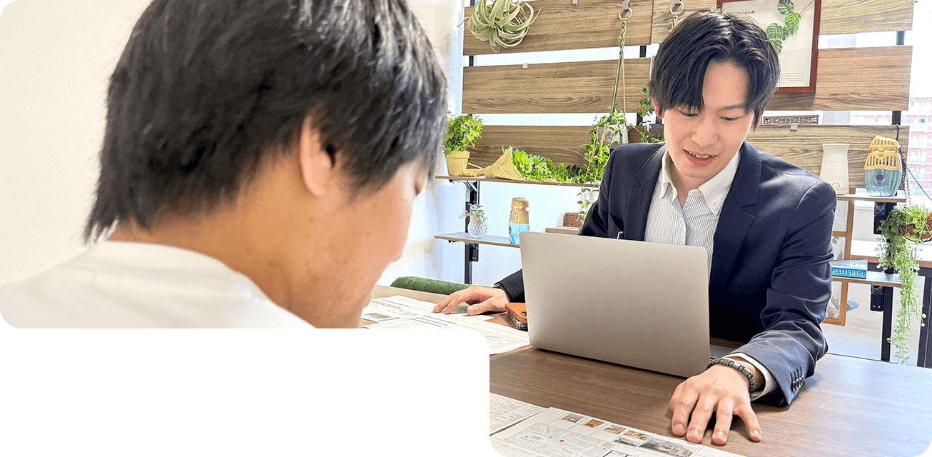 株式会社フォーユーのスタッフがお客様にパソコンと資料を使って不動産の提案をしている様子