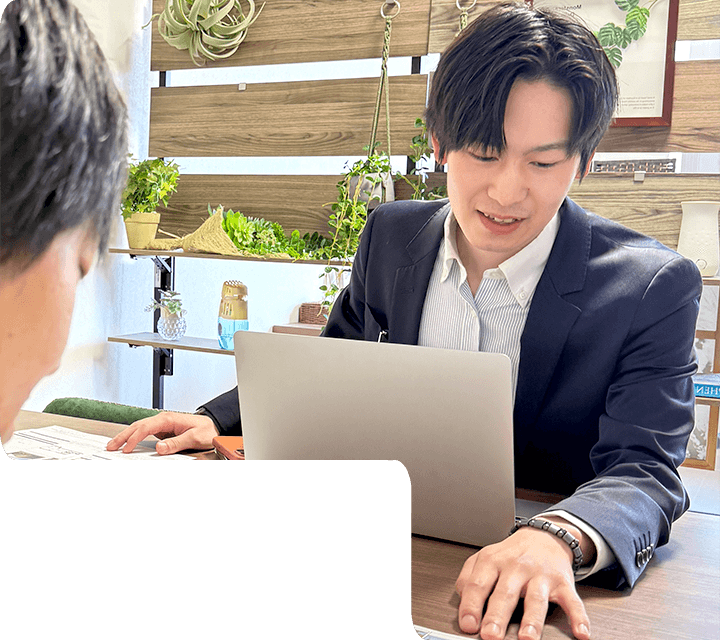 株式会社フォーユーのスタッフがお客様にパソコンと資料を使って不動産の提案をしている様子